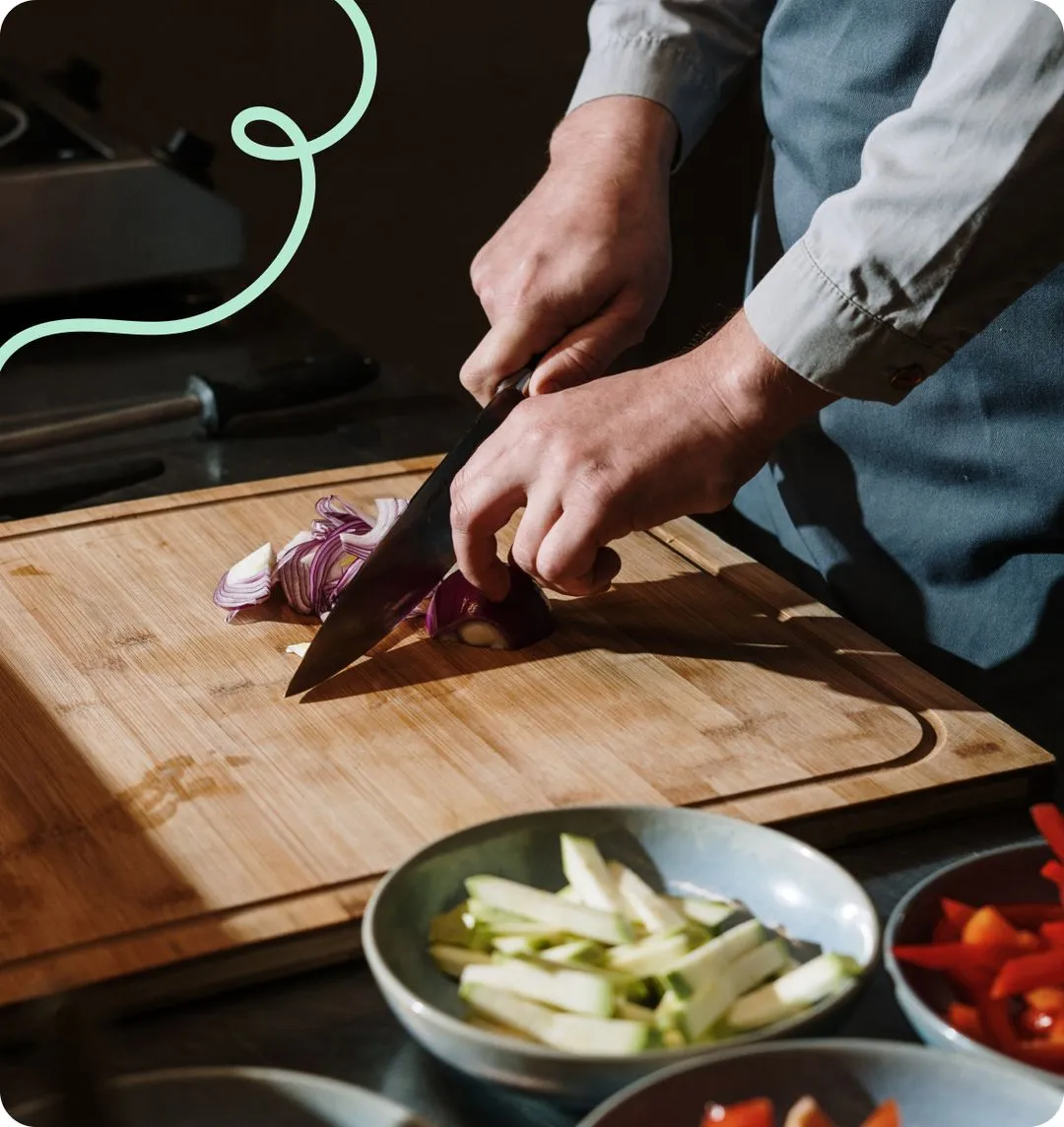 A man chopping onion